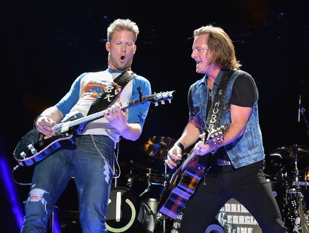 Tyler Hubbard's Solo Career - Brian Kelley and Tyler Hubbard of FGL perform on stage wearing jeans and t-shirts.s in 2013. 